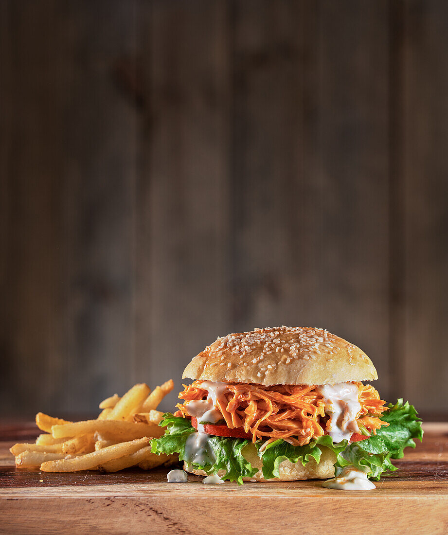 Buffalo chicken sandwich with lettuce, tomato and blue cheese dressing