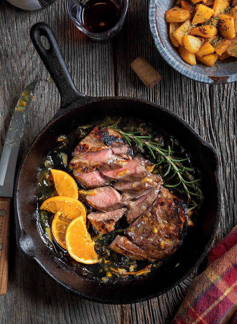 Sliced lamb chop with orange and rosemary