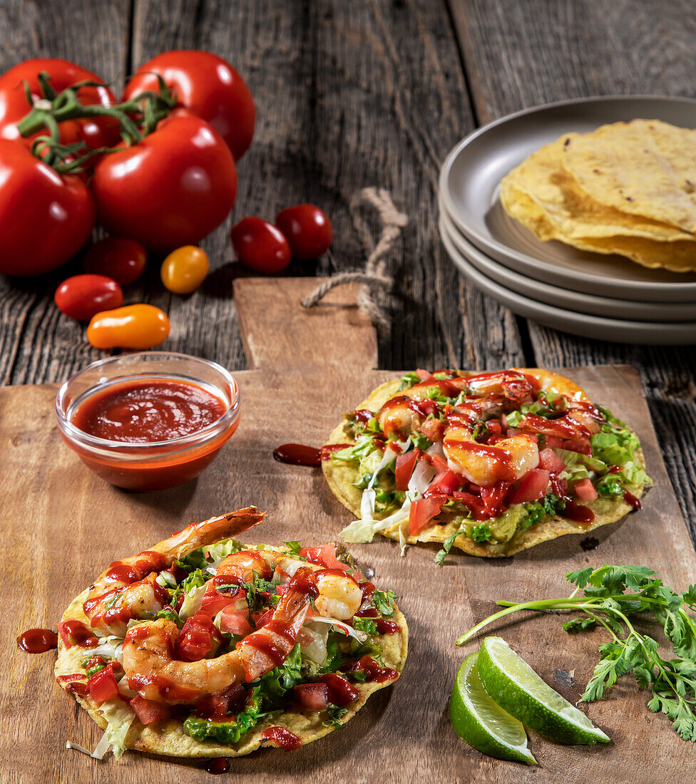 Tostadas with guacamole, lettuce, tomatoes and shrimp