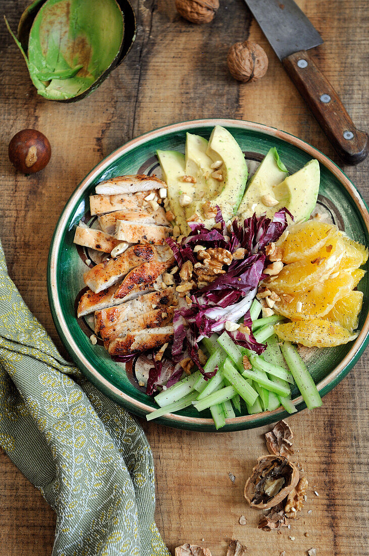 Avocado chicken salad with nuts and oranges
