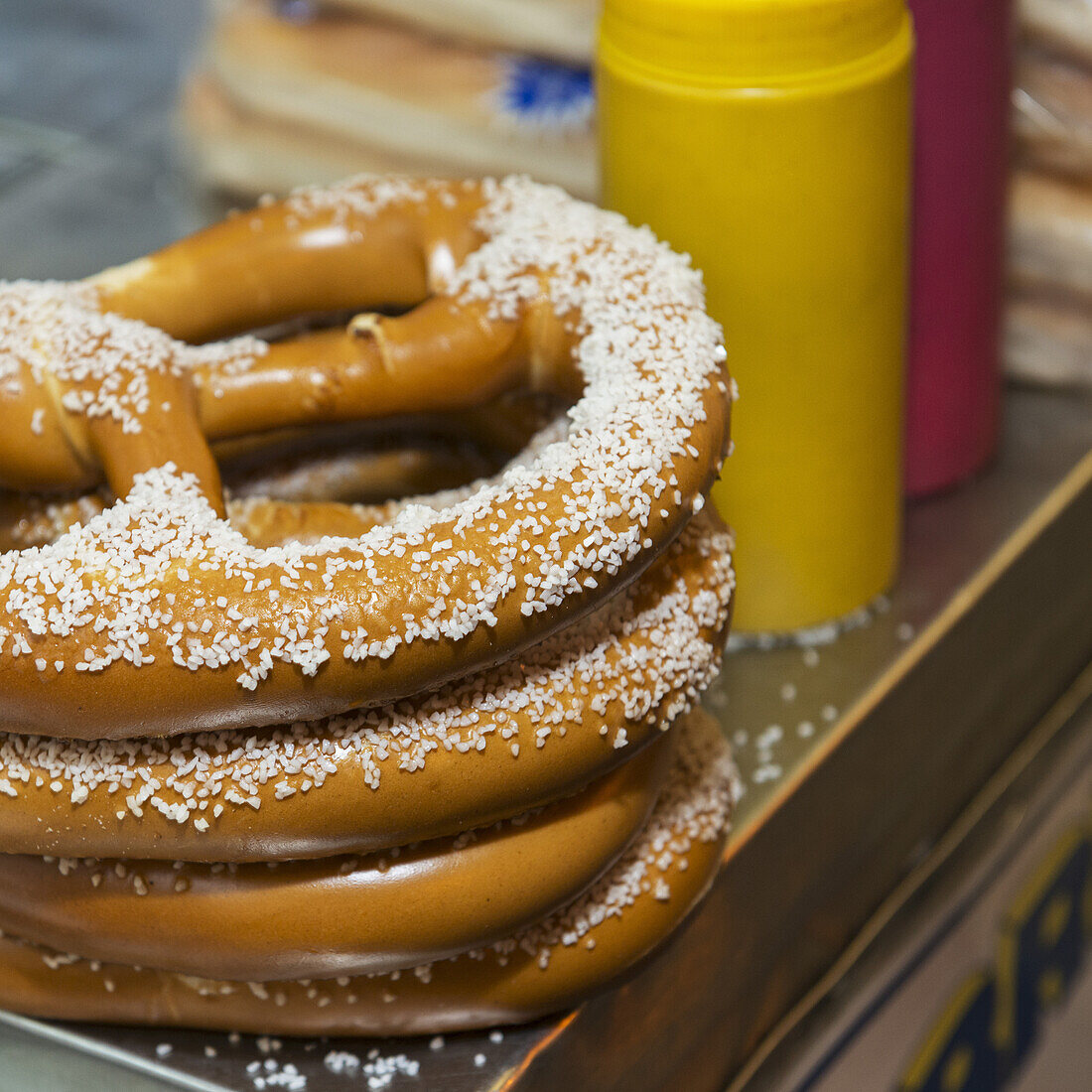 Salted Pretzels And Condiments On A Food Cart; New York City, New York, United States Of America