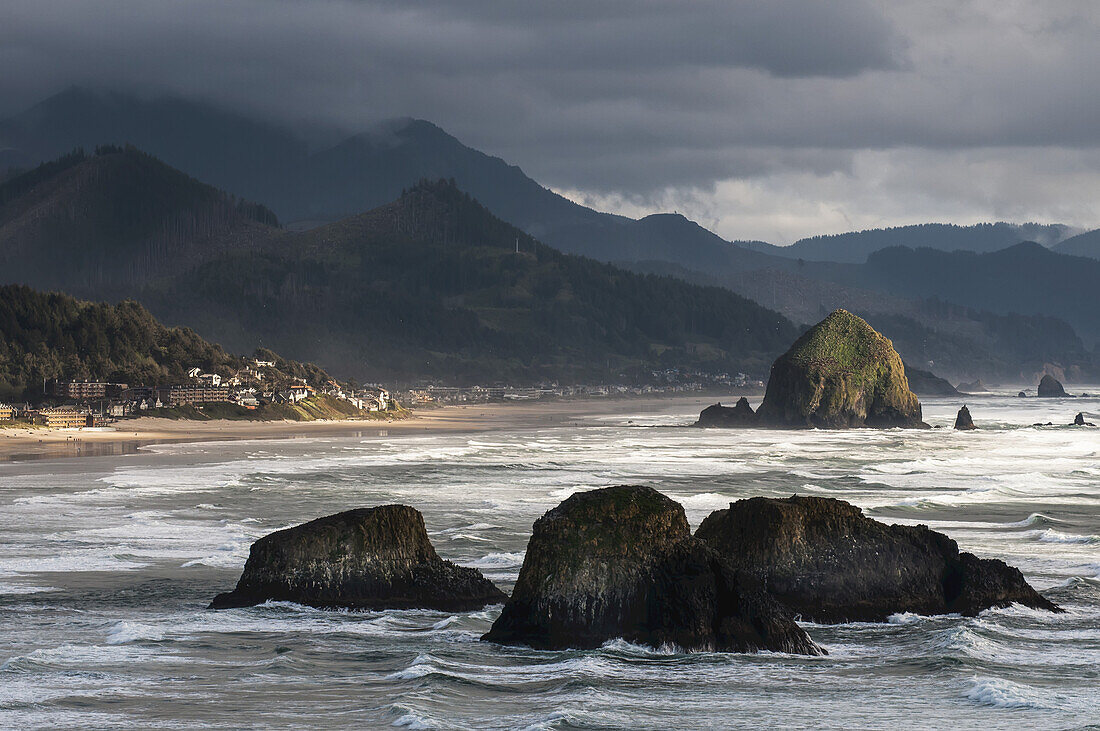 A Shaft Of Sunlight Brightens The Oregon Coast; Cannon Beach, Oregon, United States Of America