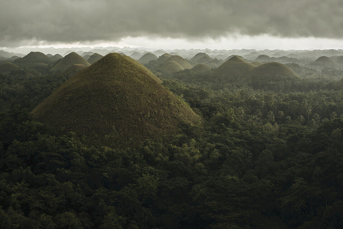 Chocolate Hills Landscape From Bohol Island, A Big Storm Covers The Sky Making An Interesting Lighting Effect; Carmen, Bohol Island, Philippines