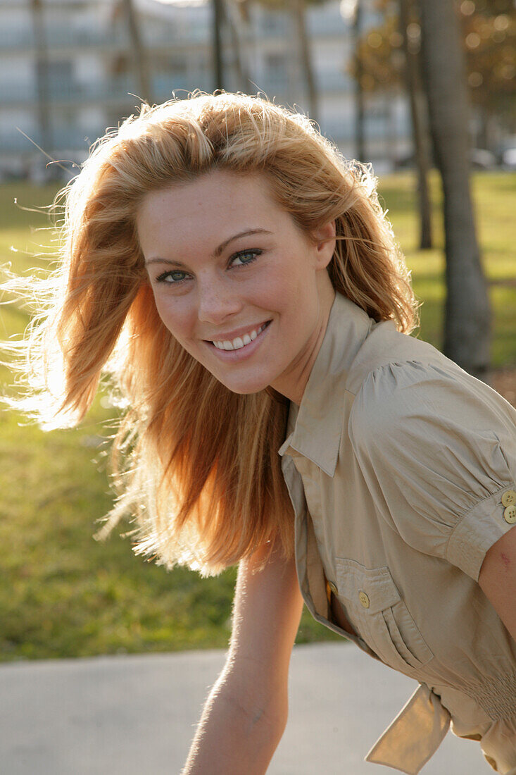 Blonde woman in light blouse dress outside