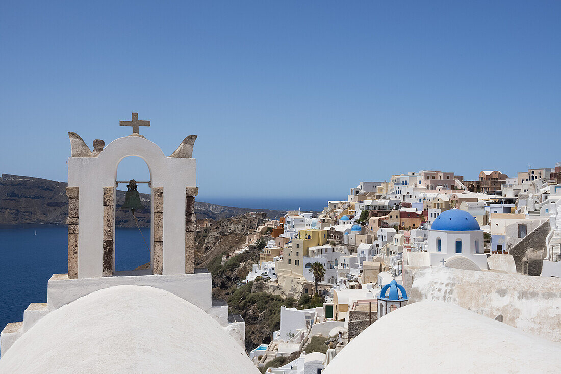 A Church Bell Tower And Traditional Painted Houses Overlooking The Caldera; Oia, Santorini, Cyclades, Greek Islands, Greece