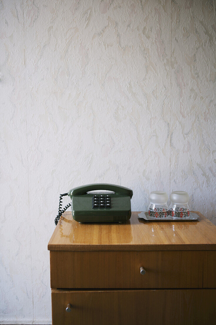 Hotel Nightstand With Push-Button Phone And Water Glasses, Textured Wallpaper; Kiev, Ukraine