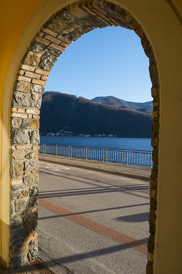 View Of Lake Lugano Through An Archway; Lugano, Ticino, Switzerland
