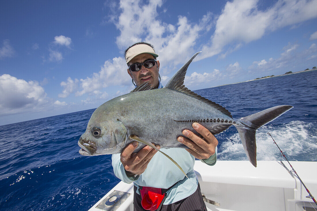 Fisherman Holding A Fresh Caught Jackfish; Tahiti