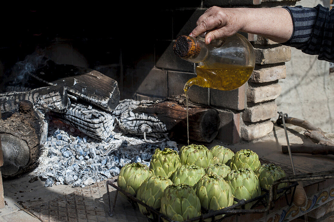 Artichokes With Olive Oil Soon To Be Cooked; Tarragona, Benissanet, Spain