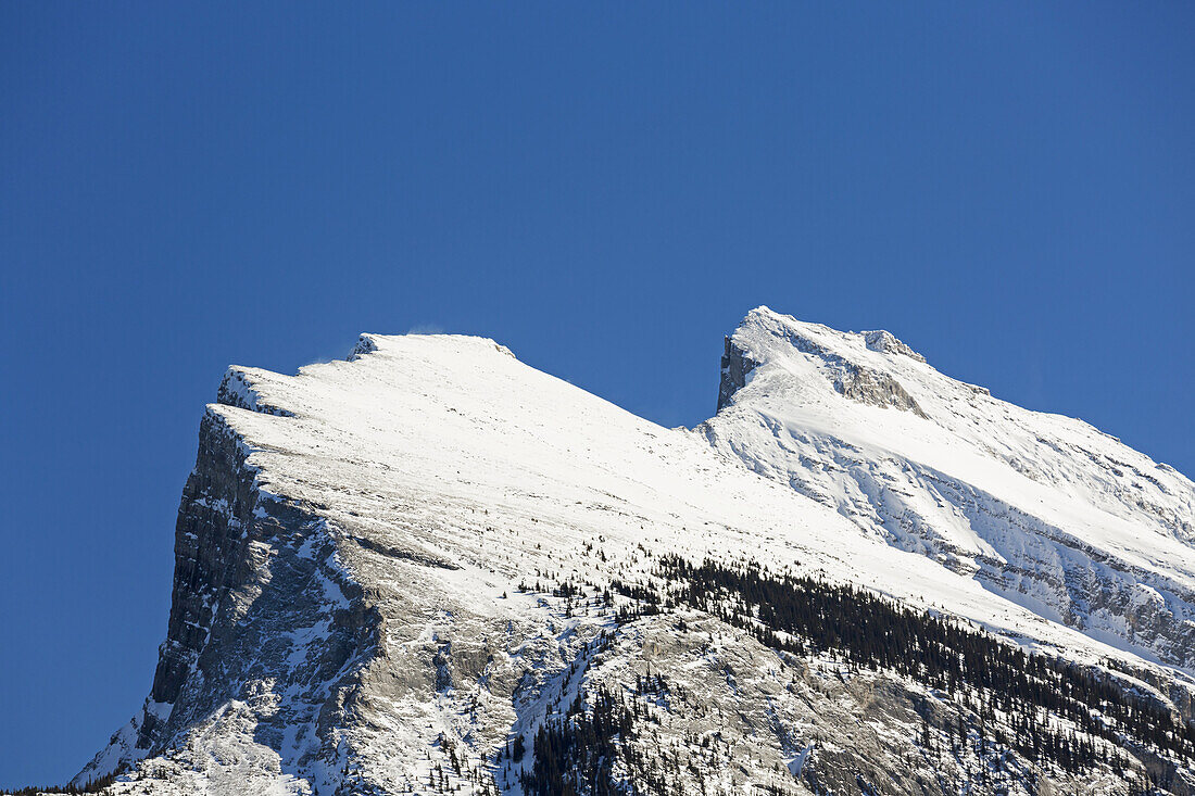 Close Up Of A Snow Covered Mountain Peak And Blue Sky; Banff, Alberta, Canada