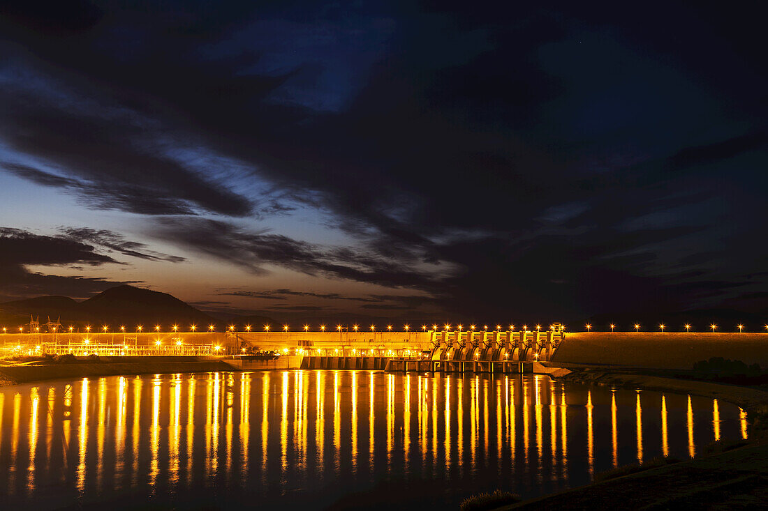 Dam Over The Euphrates River Lit Up At Nighttime; Turkey