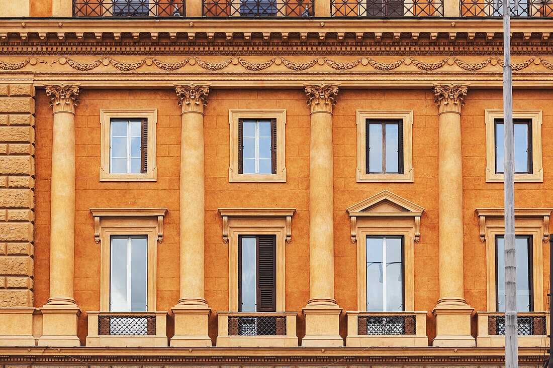 Orange Building With Pillars On The Facade; Rome, Italy