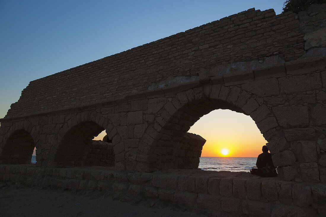 Roman Aqueduct With Arches At Sunset In Caesarea Maritima National Park; Israel