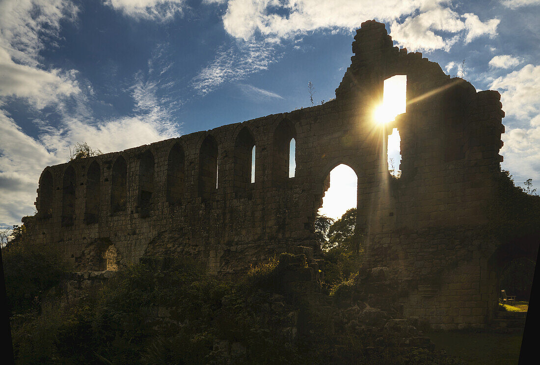 Ruins Of Jeraulx Abbey With Sunlight Shining Through A Window; Yorkshire Dales, England