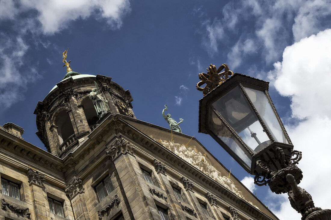 Low Angle View Of A Building And Ornate Lamp Post; Amsterdam, Netherlands