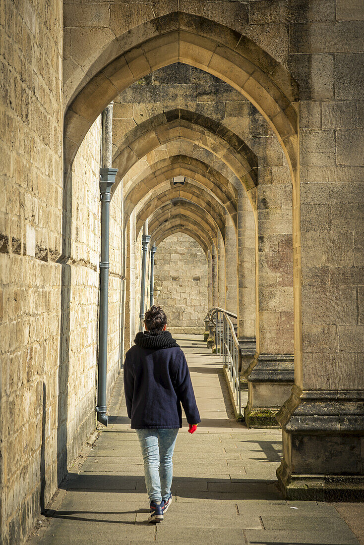 Pedestrian Walking By Winchester Cathedral; Winchester, Hampshire, England