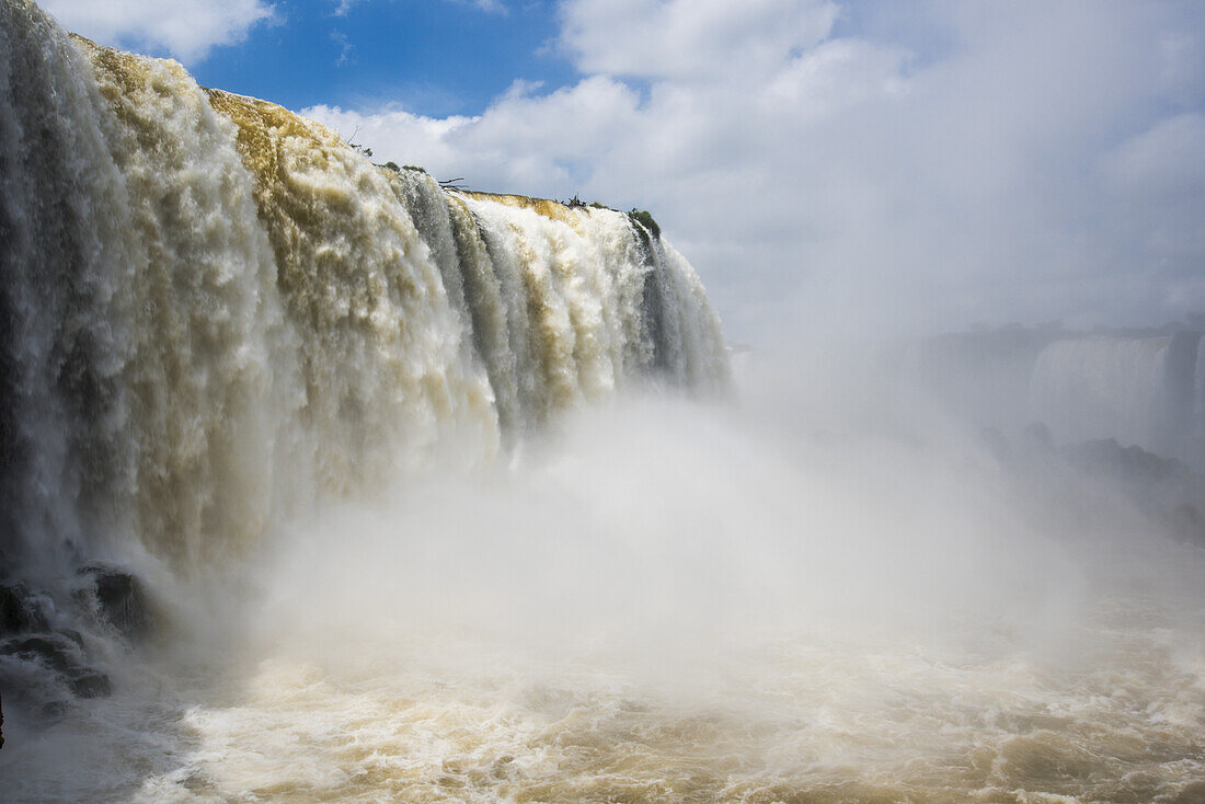 Cloud Of Spray Beneath Sunny Iguazu Falls; Parana, Brazil