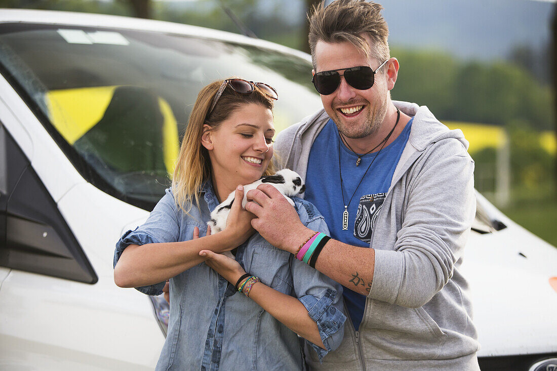 A Couple Holding A Bunny Rabbit; Cesky Krumlov, Czech Republic