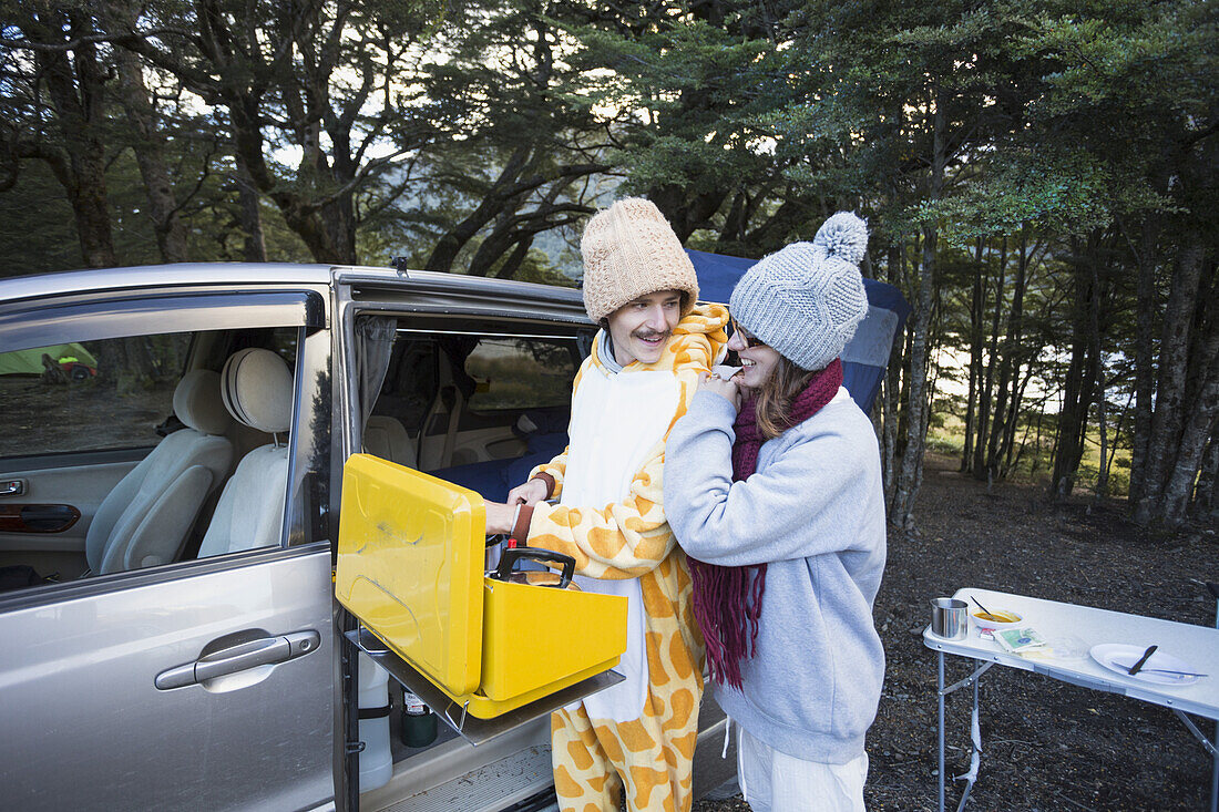 A Young Couple Camping And Keeping Warm At Mavora Lake; Mavora, Southland, New Zealand