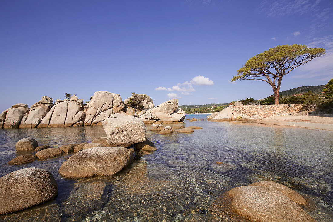 Sandy Beach/Bay With Rock Formations In Calm, Crystal Clear Sea