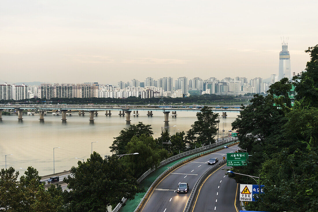 Bridges Crossing The Han River And A Road With Buildings In A Cityscape; Seoul, South Korea