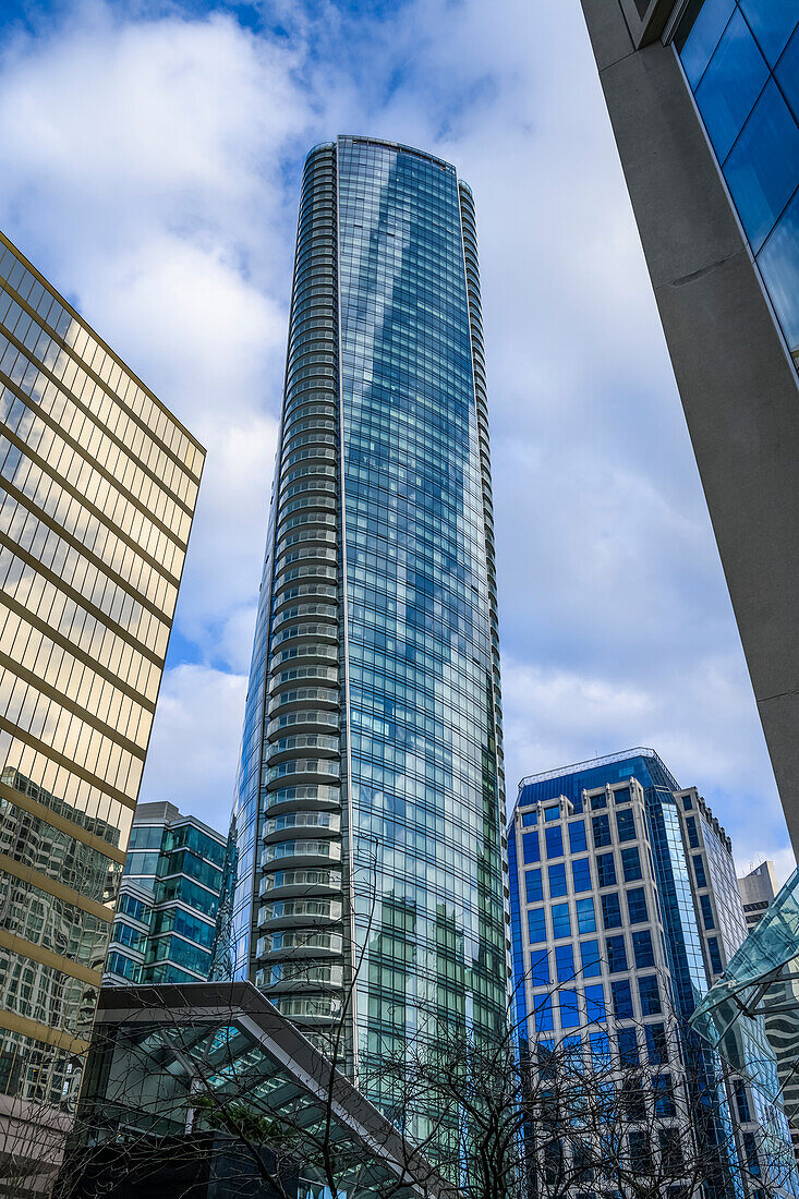 Skyscraper with glass facade reflecting blue sky and clouds; Vancouver, British Columbia, Canada