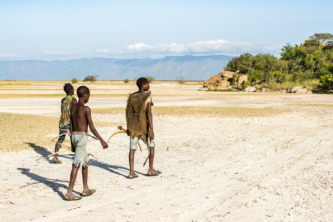 Hadzabe hunters returning to camp after a successful morning hunt near Lake Eyasi; Tanzania