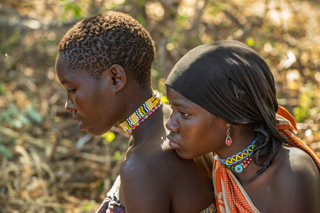 Close-up of two young Hadzabe women wearing colourful beaded jewelry near Lake Eyasi; Tanzania