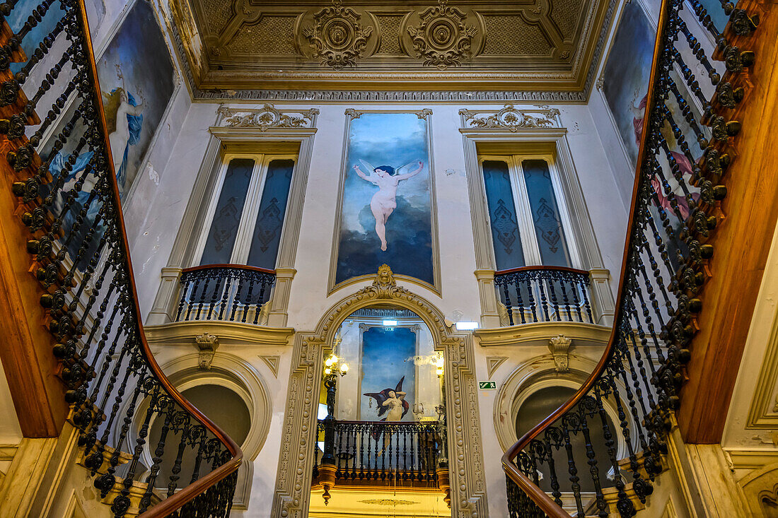 Interior of a building with artwork and decorative stair railings; Lisbon, Lisboa Region, Portugal