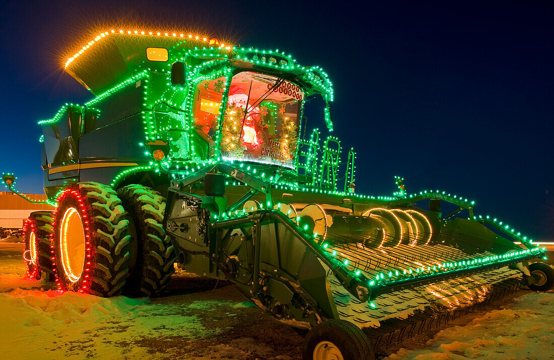 Combine harvester with Christmas lights; Manitoba, Canada