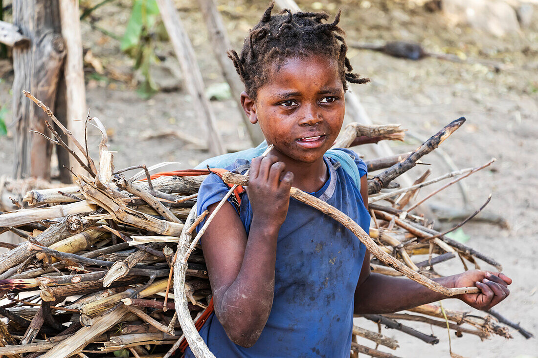 Ari-Mädchen trägt ein Reisigbündel; Jinka, Region der südlichen Nationalitäten und Völker, Äthiopien