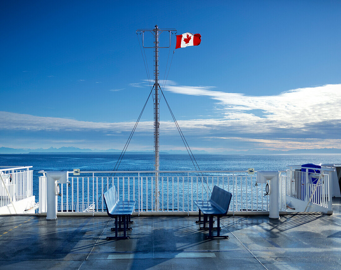 Deck of the new BC Ferry with a Canadian Flag, going to Mayne Island; British Columbia, Canada