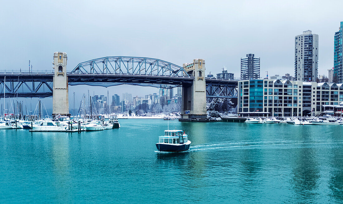 Burrard Street Bridge and a view of Granville Island with boats in False Creek; Vancouver, British Columbia, Canada