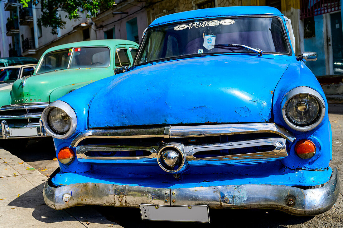 Vintage cars parked at a curb; Havana, Cuba