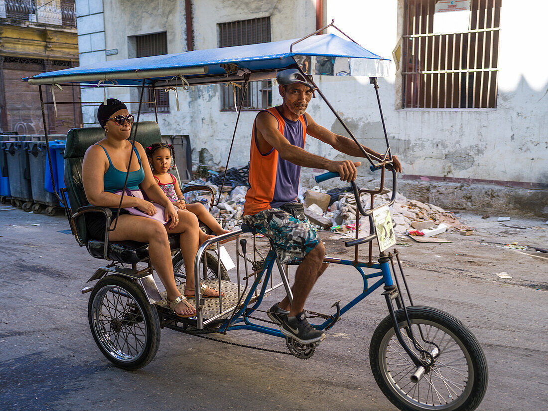 Pedicab with another and daughter on the streets of Havana; Havana, Cuba