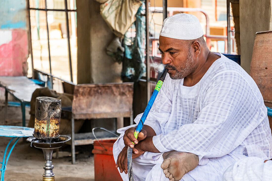 Sudanese, der eine Wasserpfeife raucht; Abri, Bundesstaat Nord, Sudan