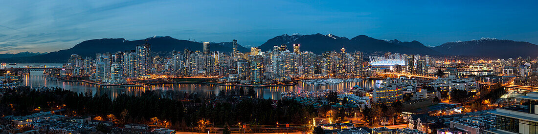 Panorama of lights illuminating the city of Vancouver at night; Vancouver, British Columbia, Canada