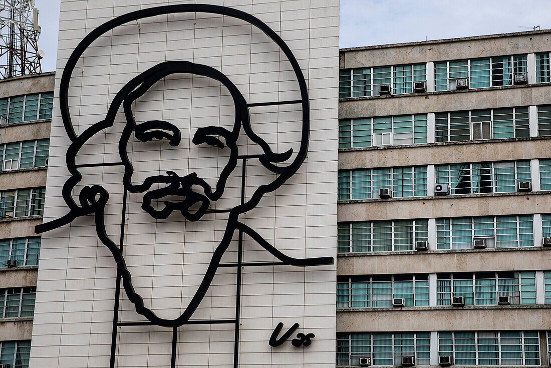 Art feature of revolutionary Emilio Cienfuegos on the side of a government building; Havana, Cuba