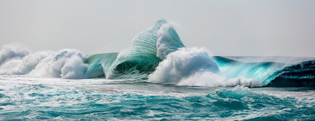 Large ocean waves crashing along the Na Pali Coast; Kauai, Hawaii, United States of America