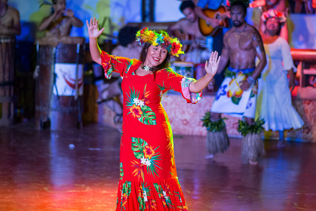 Polynesian female dancer in red dress performing on stage; Hanga Roa, Easter Island, Chile