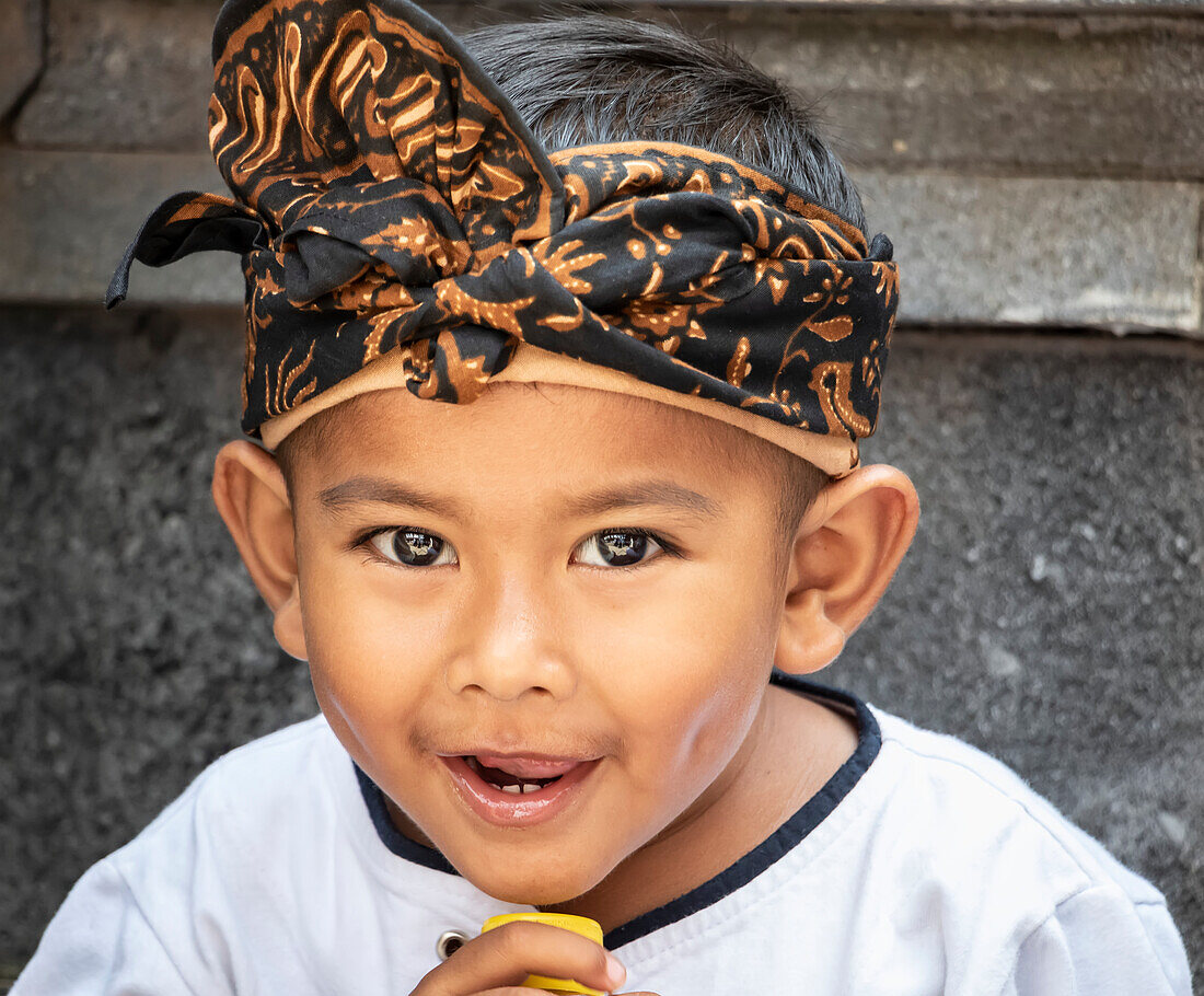 Balinese boy at a temple ceremony; Marga, Bali, Indonesia