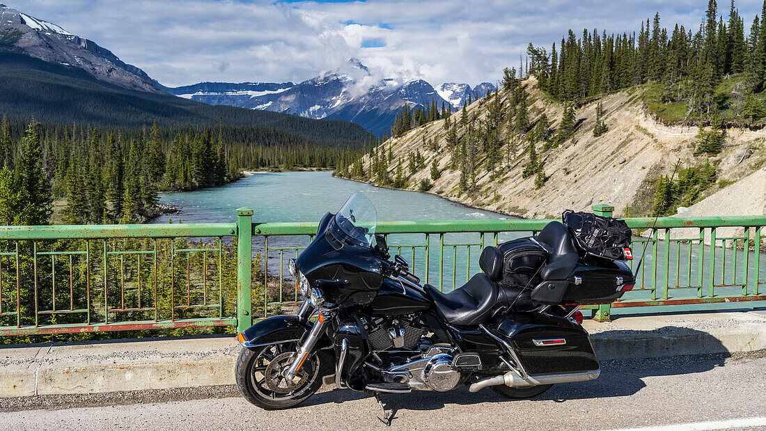 Motorcycle parked on the roadside of the Icefield Parkway on a bridge over the Athabasca River; Improvement District No. 12, Alberta, Canada