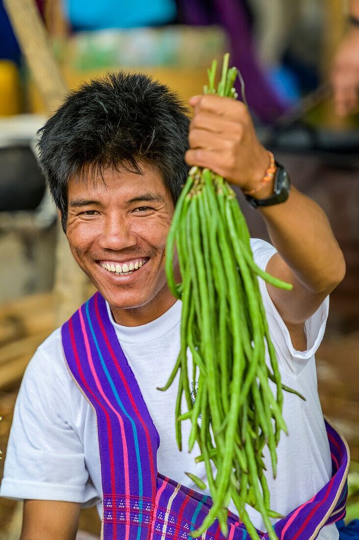 Man holding fresh beans; Shan State, Myanmar