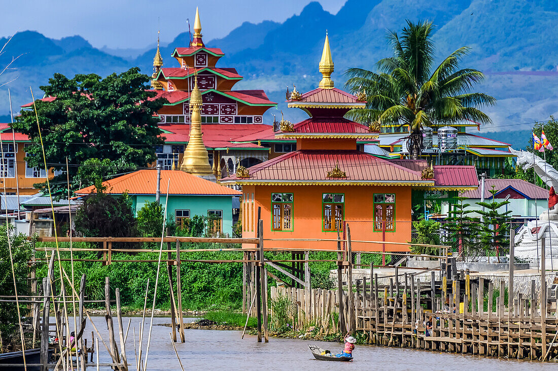 Colourful traditional temple architecture and a tranquil lake; Yawngshwe, Shan State, Myanmar