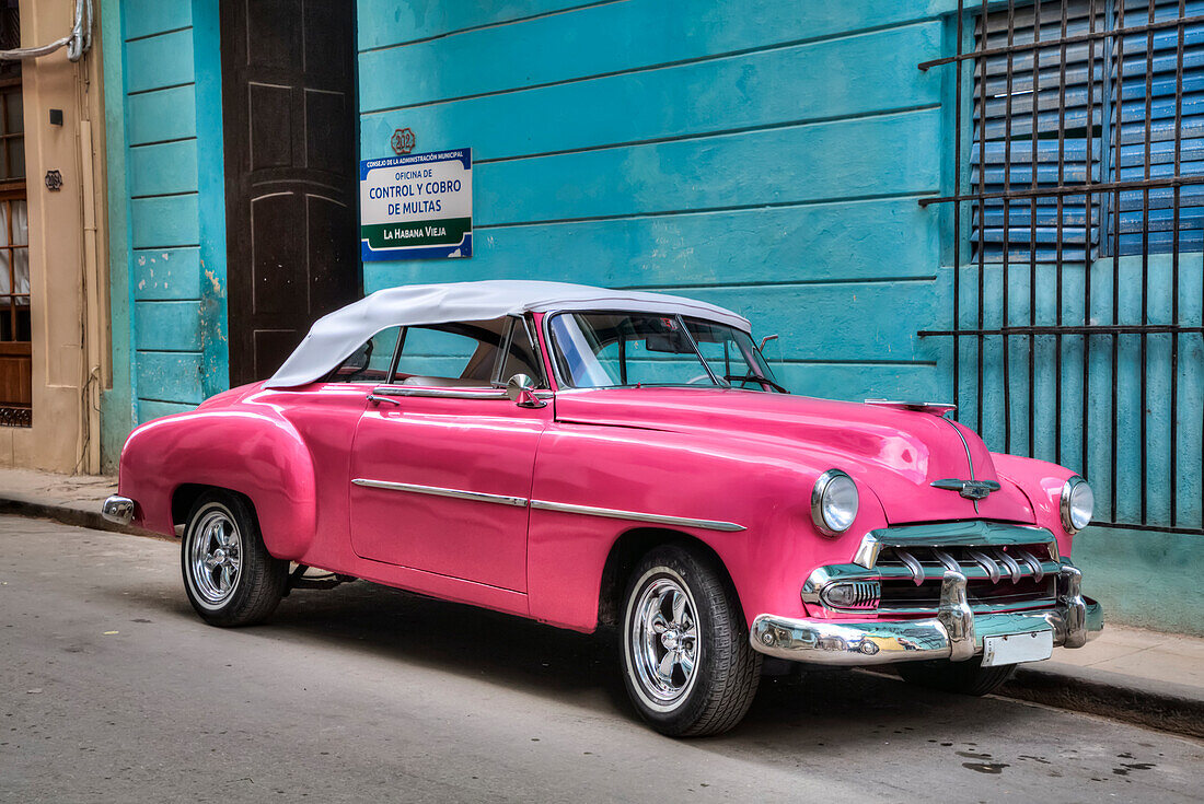 Pink classic old car parking on a street in Old Town; Havana, Cuba