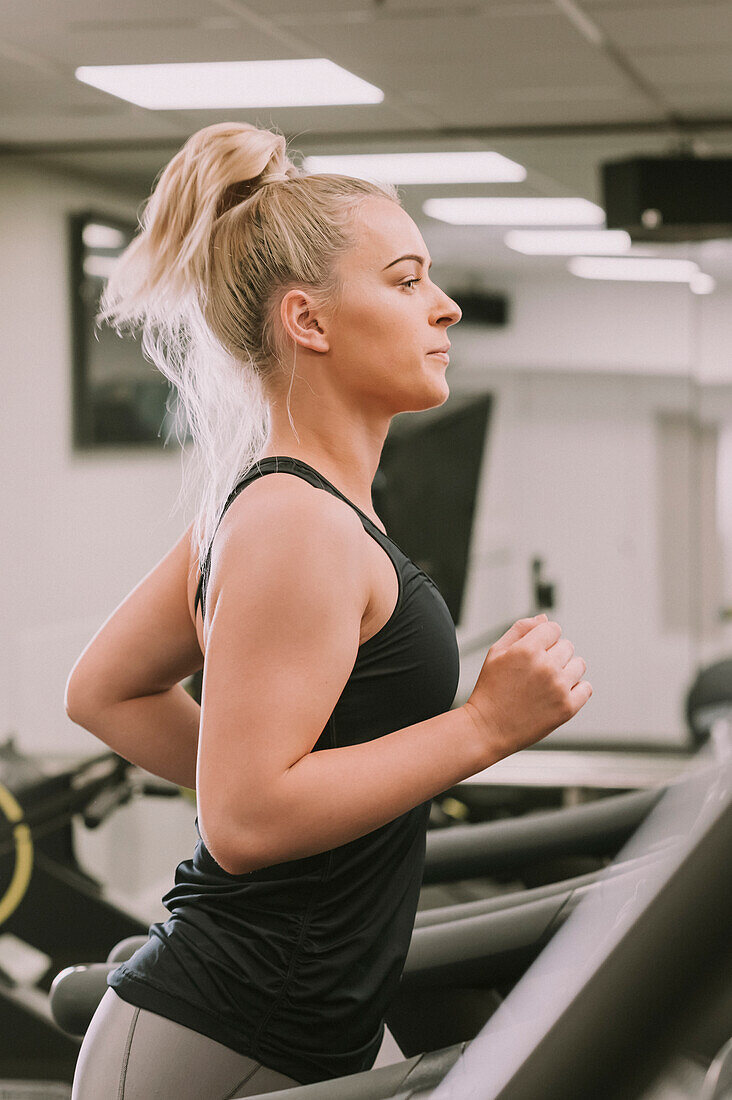 Woman working out on a treadmill; Wellington, New Zealand