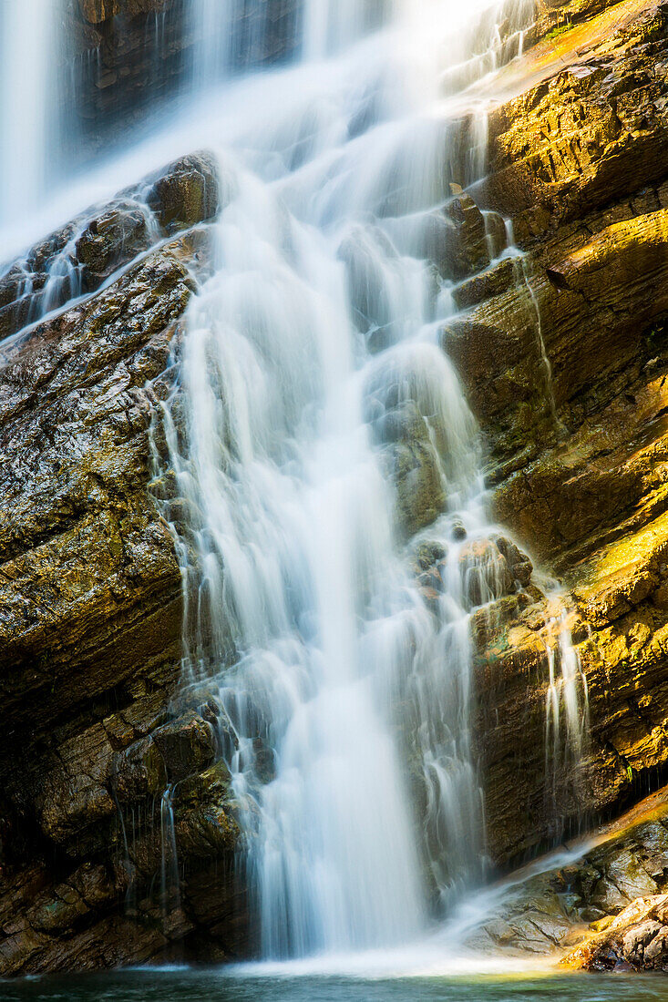 Close-up of waterfalls on angled rocky cliff, Waterton Lakes National Park; Waterton, Alberta, Canada