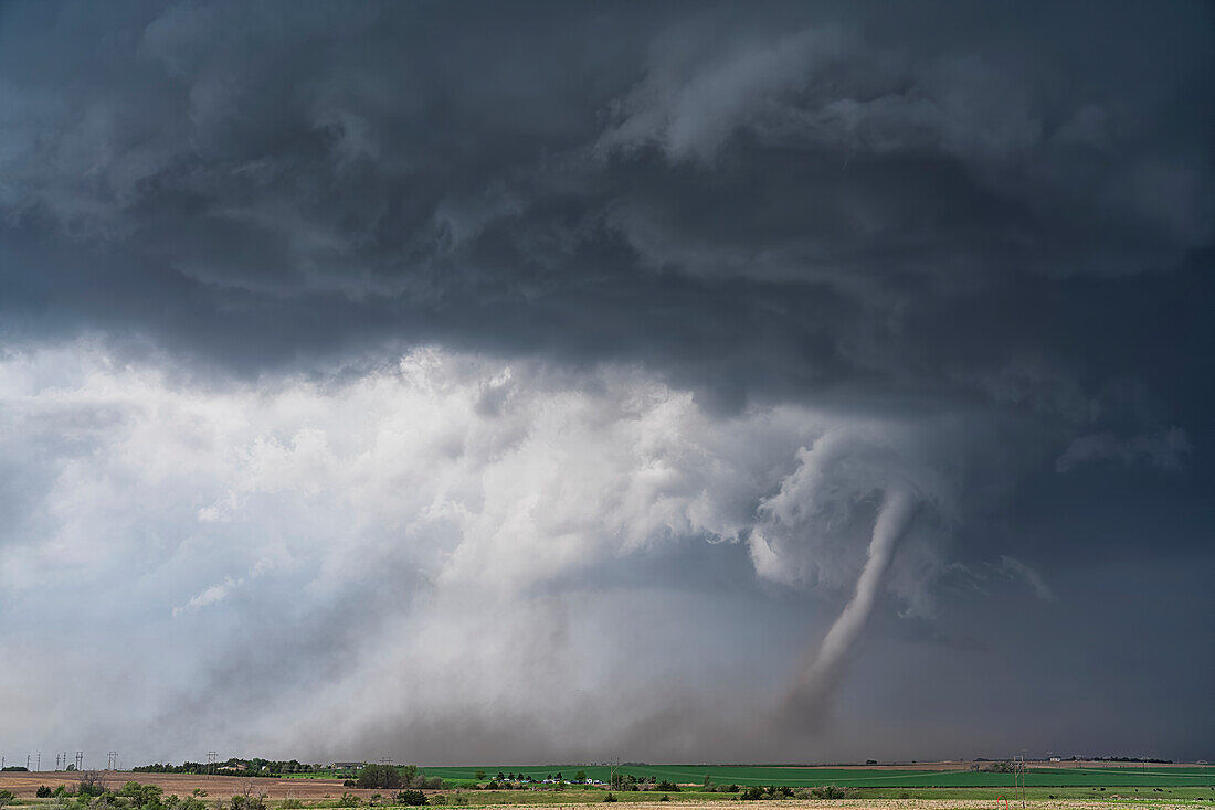 Amazing clouds over the landscape of the American mid-west as supercell thunderstorms develop.  Tornado on the ground; Woodward, Nebraska, United States of America