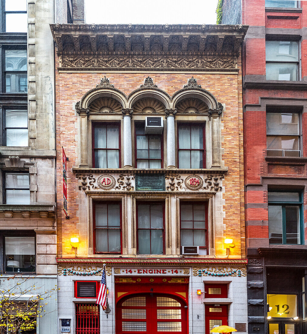 Fire Station 14 with flags and historic facade, Manhattan; New York City, New York, United States of America