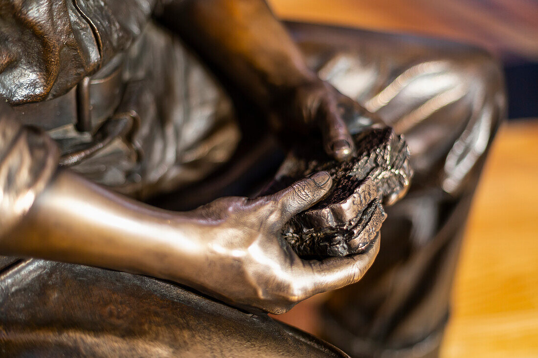 Close-up of a statue of worker eating a sandwich, Empire State Building; New York City, New York, United States of America